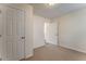 Bedroom with neutral walls and carpet, one window, and a door leading to wood floors at 60 Kyler Way Way, Dallas, GA 30157