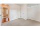 Bedroom with neutral carpet and walls, closet, and door leading to a room with wood floors at 60 Kyler Way Way, Dallas, GA 30157