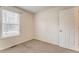 Bedroom featuring a window, neutral carpet, white walls, baseboards, and a closed door at 60 Kyler Way Way, Dallas, GA 30157