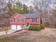 Traditional exterior elevation, with red siding, two car garage and landscaped front yard at 60 Kyler Way Way, Dallas, GA 30157