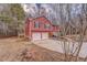 Exterior view showcasing the home's facade, two-car garage and side wooden deck at 60 Kyler Way Way, Dallas, GA 30157