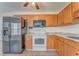 Spacious kitchen featuring a large refrigerator, wood cabinets and modern appliances at 60 Kyler Way Way, Dallas, GA 30157