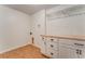 Functional laundry room with white cabinets, wooden countertop, and laminate flooring at 60 Kyler Way Way, Dallas, GA 30157