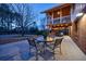 Outdoor patio with dining table and chairs, next to a cozy screened-in porch at 180 Saddle Creek Dr, Roswell, GA 30076