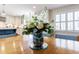 Close-up of a dining table with a floral centerpiece, with the bright kitchen in the background at 180 Saddle Creek Dr, Roswell, GA 30076