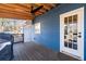 Covered back porch with access to the backyard, wood floors, and wood railing at 1981 Lindsey Ln, Decatur, GA 30035