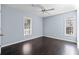 Bright bedroom features two windows, dark wood floors, and neutral walls creating a serene atmosphere at 1981 Lindsey Ln, Decatur, GA 30035