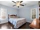 Cozy bedroom featuring hardwood floors, two windows, and a ceiling fan at 1981 Lindsey Ln, Decatur, GA 30035