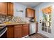 Kitchen boasts a stainless steel dishwasher and sink, along with a door that opens to the outdoor deck at 1981 Lindsey Ln, Decatur, GA 30035