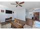 Living room featuring hardwood floors, a ceiling fan, and a TV mounted on the wall at 1981 Lindsey Ln, Decatur, GA 30035