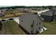 Aerial view of a spacious backyard with a well-maintained lawn, mature trees, and a home featuring a traditional design at 200 Baumgard Way, Locust Grove, GA 30248