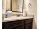 Close-up of a bathroom vanity featuring granite countertops and dark wood cabinetry at 200 Baumgard Way, Locust Grove, GA 30248
