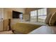 Bedroom showcasing neutral walls, a comfortable bed, and a TV for relaxation and entertainment at 200 Baumgard Way, Locust Grove, GA 30248