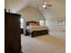 Large bedroom featuring a vaulted ceiling, plush carpet, and comfortable furnishings at 200 Baumgard Way, Locust Grove, GA 30248