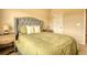This bedroom boasts a tufted headboard and serene decor, creating a peaceful retreat at 200 Baumgard Way, Locust Grove, GA 30248