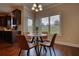 Bright breakfast nook features a round table, modern chairs, and a view of the backyard at 200 Baumgard Way, Locust Grove, GA 30248