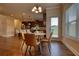 Open-concept breakfast nook with modern chairs and a view of the kitchen with a center island at 200 Baumgard Way, Locust Grove, GA 30248