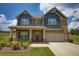 Charming two-story home with a well-manicured lawn and a two-car garage at 200 Baumgard Way, Locust Grove, GA 30248