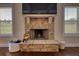 Close up of a stone fireplace with decorative details, adding warmth and character to the living space with natural light at 200 Baumgard Way, Locust Grove, GA 30248