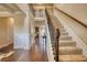 Spacious foyer featuring hardwood floors, staircase with iron railing, and elegant trim at 200 Baumgard Way, Locust Grove, GA 30248