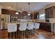 Spacious kitchen features a center island, stainless steel appliances, and bar stool seating at 200 Baumgard Way, Locust Grove, GA 30248
