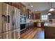Gourmet kitchen with stainless steel appliances, dark wood cabinetry, and an open layout at 200 Baumgard Way, Locust Grove, GA 30248