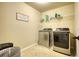 Functional laundry room with modern washer and dryer, shelving, and ample space at 200 Baumgard Way, Locust Grove, GA 30248