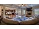 Open-concept living space with hardwood floors, a cozy fireplace, and views of the kitchen and dining area at 200 Baumgard Way, Locust Grove, GA 30248