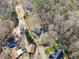 Great aerial showcasing large lot, wooded area, mature trees and sparkling blue pool at 2570 Curtis Sw Rd, Marietta, GA 30064