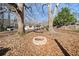 Backyard with fire pit and home exterior nestled amongst mature trees and foliage at 2570 Curtis Sw Rd, Marietta, GA 30064