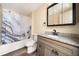 Bathroom featuring granite vanity top, decorative shower curtain and wood plank flooring at 2570 Curtis Sw Rd, Marietta, GA 30064