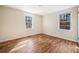 Cozy bedroom features hardwood floors and natural light from two windows at 2570 Curtis Sw Rd, Marietta, GA 30064