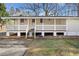 Quaint home with large front porch, white railings and a well-maintained lawn at 2570 Curtis Sw Rd, Marietta, GA 30064