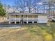 Charming ranch-style house featuring a covered porch with white railings and a spacious yard at 2570 Curtis Sw Rd, Marietta, GA 30064