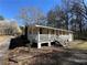 Ranch style home with a long porch and white railings in a wooded setting at 2570 Curtis Sw Rd, Marietta, GA 30064