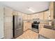 Well-lit kitchen featuring stainless steel appliances, light cabinetry and tile floors at 2570 Curtis Sw Rd, Marietta, GA 30064