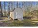 Backyard features a useful outbuilding with double doors, enhancing storage and utility at 2570 Curtis Sw Rd, Marietta, GA 30064