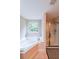Bathroom features a soaking tub, shower with glass door, and a window at 4007 Fellowship Dr, Buford, GA 30519