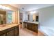 Full bathroom with double vanity, soaking tub, and glass door shower at 4007 Fellowship Dr, Buford, GA 30519