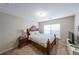 Cozy bedroom with carpet, window, TV on white dresser, and bedside table at 4007 Fellowship Dr, Buford, GA 30519