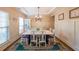 Elegant dining room with a large table, chandelier, and decorative accents at 4007 Fellowship Dr, Buford, GA 30519