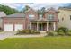 Charming two-story red brick home with a manicured front yard and a two-car garage at 4007 Fellowship Dr, Buford, GA 30519