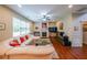 Cozy living room with hardwood floors, a fireplace, and a large sectional sofa at 4007 Fellowship Dr, Buford, GA 30519