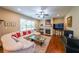 Inviting living room with a fireplace, hardwood floors, and a plush white sectional sofa at 4007 Fellowship Dr, Buford, GA 30519