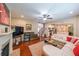 Cozy living room featuring a fireplace, ceiling fan, and hardwood floors at 4007 Fellowship Dr, Buford, GA 30519