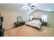 Spacious main bedroom featuring a ceiling fan, a large bed, and carpet at 4007 Fellowship Dr, Buford, GA 30519