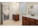 Well-lit bathroom featuring double vanity with dark wood cabinets and a view into the bedroom at 5288 Clingman Ct, Douglasville, GA 30135