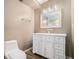 Bathroom with modern lighting, white vanity, and a large mirror at 5288 Clingman Ct, Douglasville, GA 30135