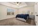 Bedroom features carpet, a ceiling fan, and a window for natural light, creating a cozy and inviting space at 5288 Clingman Ct, Douglasville, GA 30135