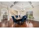 Elegant dining room features coffered ceilings, hardwood floors, and stylish blue chairs at 5288 Clingman Ct, Douglasville, GA 30135